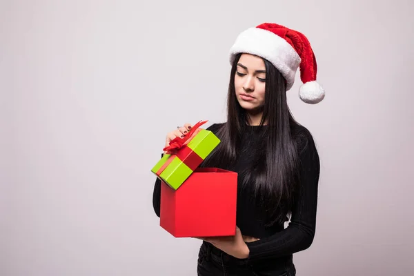 Mulher de Natal caixa de presente aberta. Menina morena bonita em Santa Chapéu isolado. Retrato — Fotografia de Stock