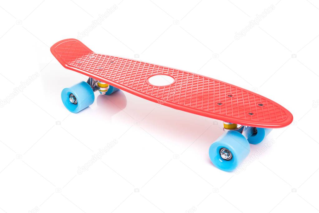 Red plastic skateboard on white background