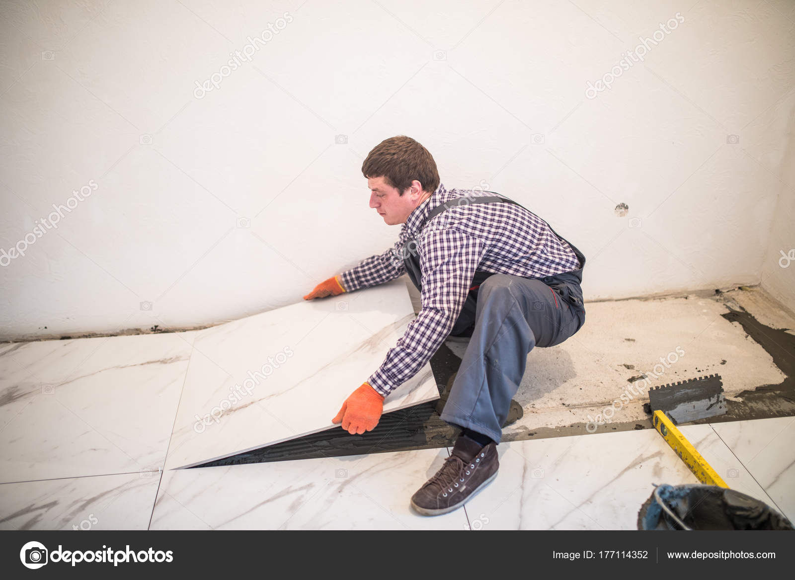 Laying Ceramic Tiles Worker Placing, How To Lay Ceramic Floor Tile