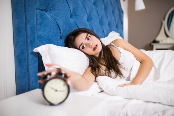 Wake up of an sleep girl stopping alarm clock on the bed in the morning — Stock Photo, Image