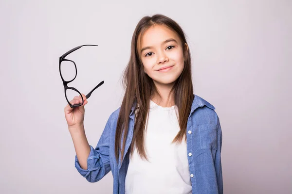 Kislány szemüveg, kezében a szürke háttér elszigetelt boldog szépség portréja — Stock Fotó