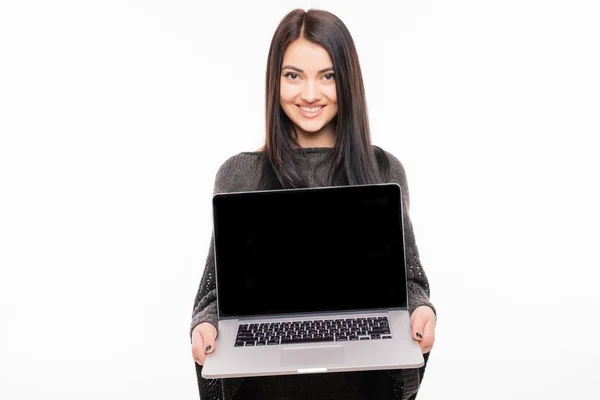 Portrait of young woman using laptop standing on white background — Stock Photo, Image