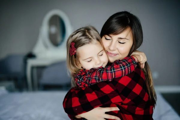 美丽的年轻女子和她迷人的小女儿拥抱和微笑。幸福家庭 — 图库照片
