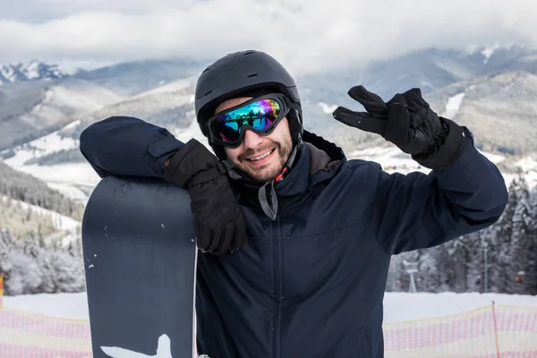 Snowboarder with snowboard portrait with victory sign on the top of mountains hill before ride — Stock Photo, Image