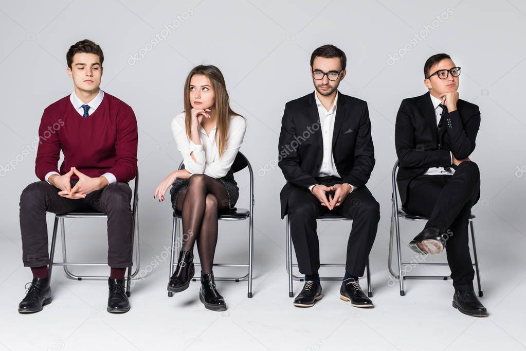 Business people waiting for job interview sitting on chair isolated on white