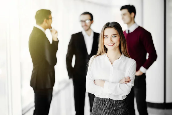 Successful young female manager in front of her team in business office — Stock Photo, Image