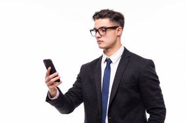 Beyaz arka plan üzerinde izole ayakta iken cep telefonunuzu kullanarak Beyaz tişörtlü neşeli bir gülümseyen adam portresi