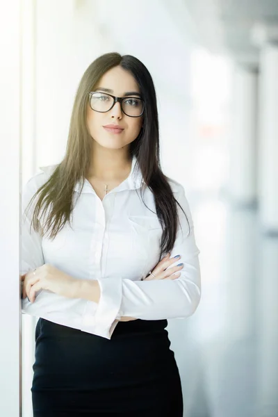 Businesswoman crossed hands portrait in office with panoramic windows. Business concept — Stock Photo, Image