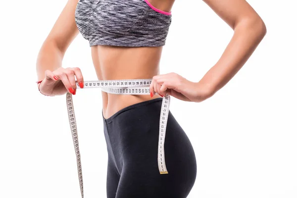 Fitness Mulher em sutiã esporte medindo seu corpo com fita isolante em branco — Fotografia de Stock