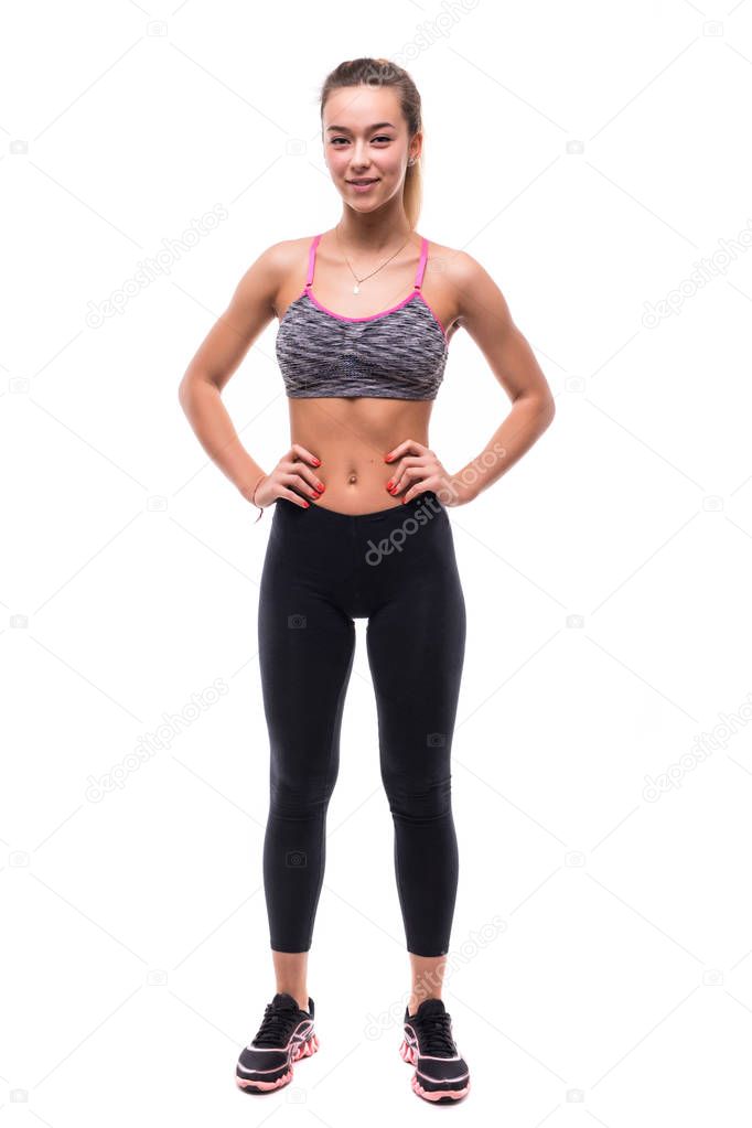 Active sporty young relaxed sportswoman in sportswear looking at camera. Full body length portrait isolated on white background.