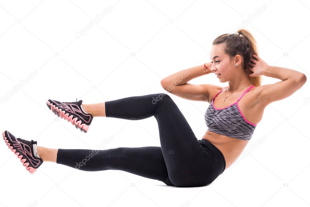 Sexy athlete performs exercises on the press on white background. Fitness, healthy lifestyle.