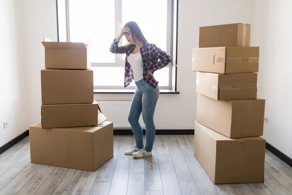 Ung kvinna har ryggskada från bära tung låda medan du flyttar hem — Stockfoto