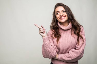 Kadın işaret parmak tarafı izole portre beyaz arka plan üzerinde gülümseyen.