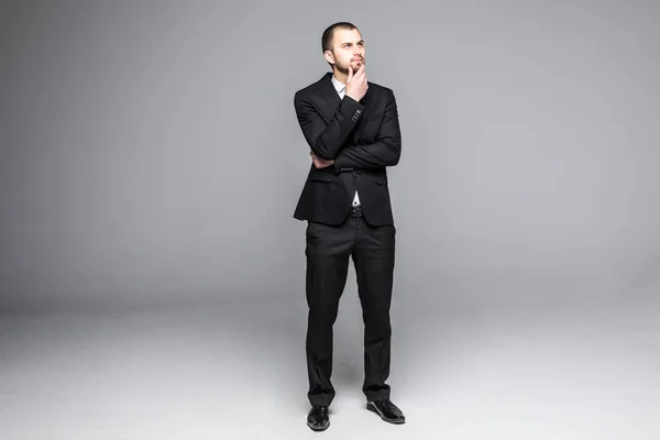 Thoughtful young business man looking isolated on white background — Stock Photo, Image