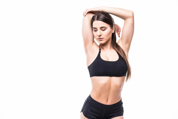 Jovem mulher bonita em fitness desgaste sobre fundo branco — Fotografia de Stock