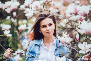 Bir çiçek açması bahar Manolya Bahçe içindeki genç güzel beyaz kız. Bahçe sabah kız.