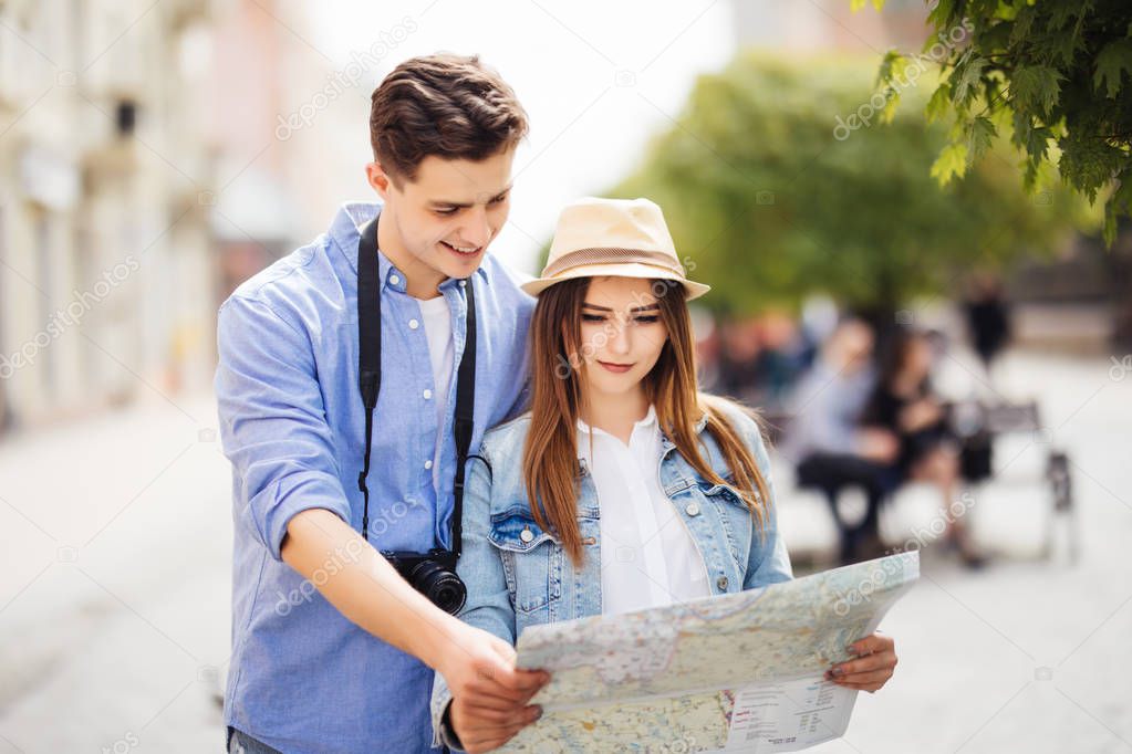 Happy tourists with map travel together and open new destination