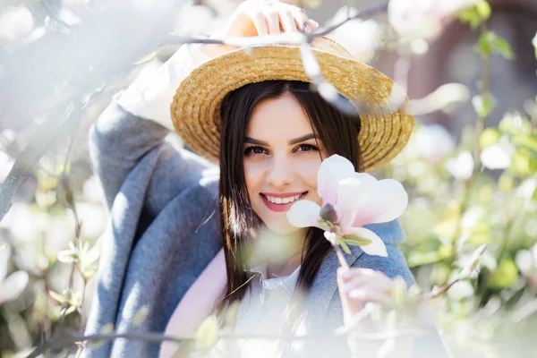 Jeune belle fille caucasienne dans un jardin de magnolia printemps florissant . — Photo