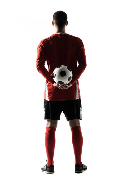 Vista traseira da silhueta do jovem jogador de futebol isolado no fundo branco — Fotografia de Stock