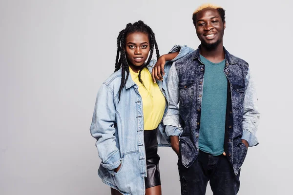 Casual couple in casual clothes smiling at camera on white background