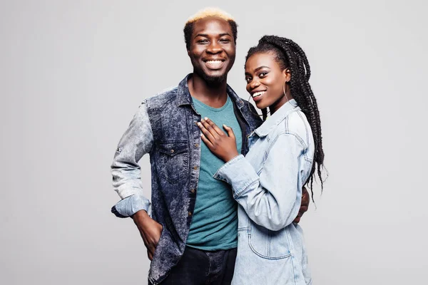 Portrait of a lovely young afro american couple hugging isolated over white