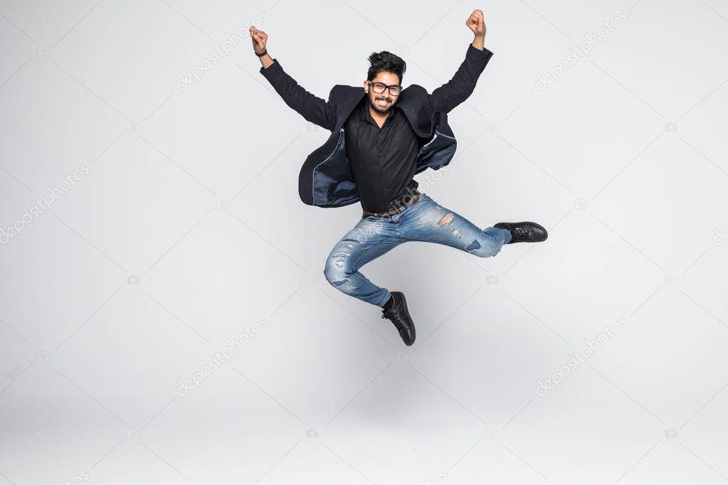 Excited Indian businessman jumping for joy isolated on white background.