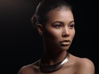 Portre ile mükemmel pürüzsüz parlak melez deri güzel çıplak bir Afrikalı-Amerikalı kadın moda, tam altın dudaklar, traş saç kesimi ve altın kolye, stüdyo çekimi, yapmak