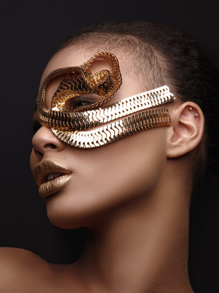 Luxury art studio portrait of an extraordinary beautiful nude african american model with perfect smooth glowing mulatto skin, make up, full golden lips, shaved haircut and gold jewelry, profile 