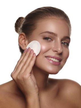 Makyaj, olmadan saf ve sağlıklı parlak deri bir pamuk kullanarak günlük temizlik işlemleri yapan bir kız portresi yastık duş, sağlık ve spa, beyaz izole arka plan sonra