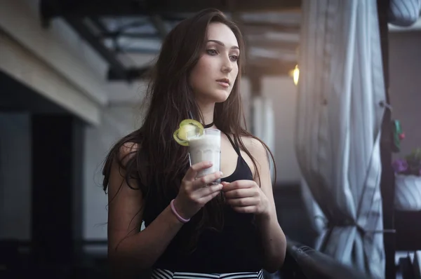 Mujer bebiendo batido de chocolate con fruta en un café al aire libre — Foto de Stock