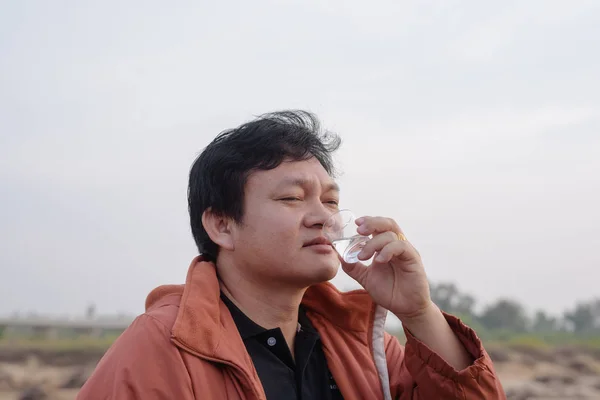 Man drinking  vodka in the camp