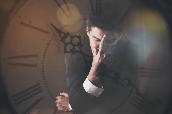 Double exposure of serious businessman and the  clock