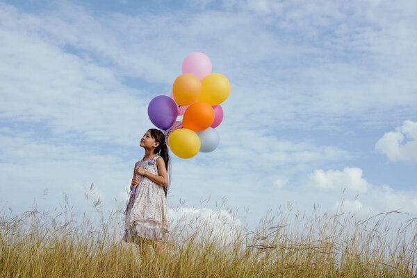 Happy girl with colorful balloons.