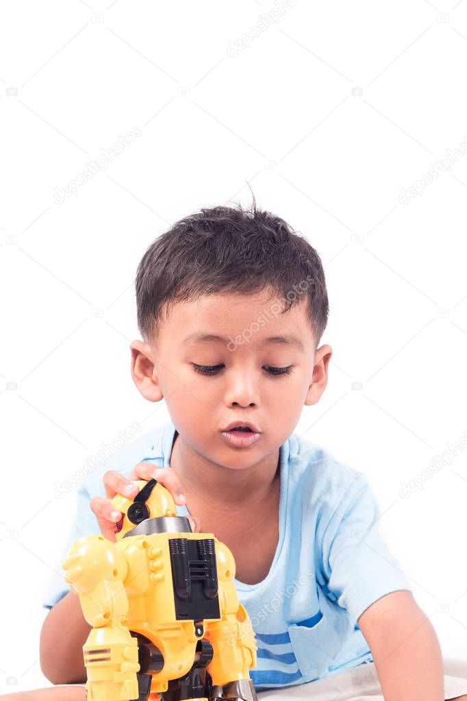 Portrait of cute child asian little boy playing robot toy