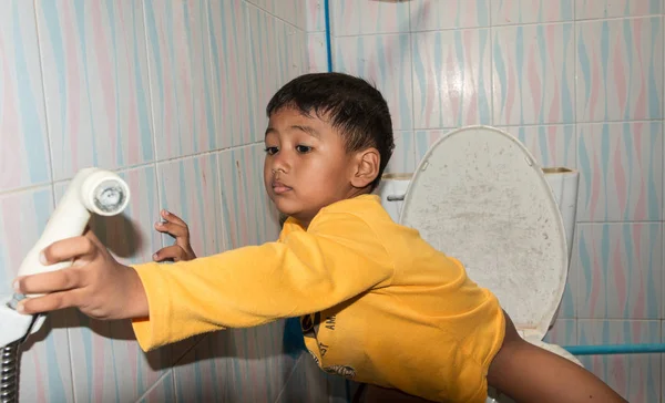 Cute child little asian boy defecate in toilet — Stock Image Cute child little asian boy defecate in toilet Stock Photo
