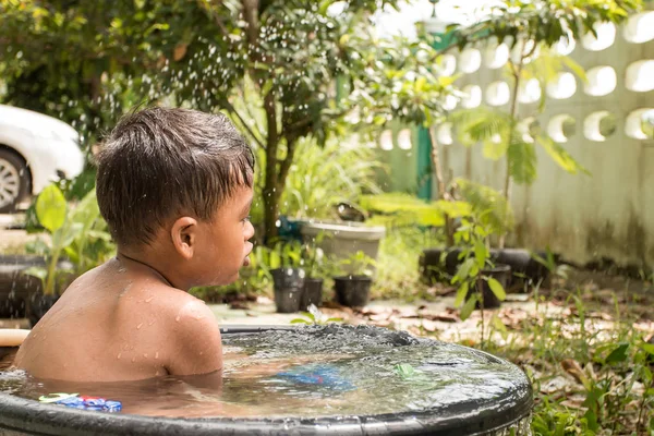 Cute little play water and take a bath in garden, vintage — стоковое фото