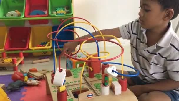 Cute asian boy play wooden toy — Stock Video