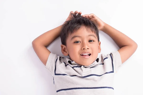 Close up of cute asian boy lying on floor — Stock Photo, Image