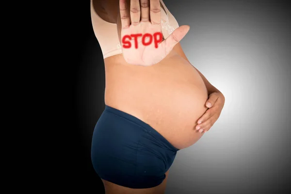 Pregnant women show hand stop on gray background — Stock Photo, Image