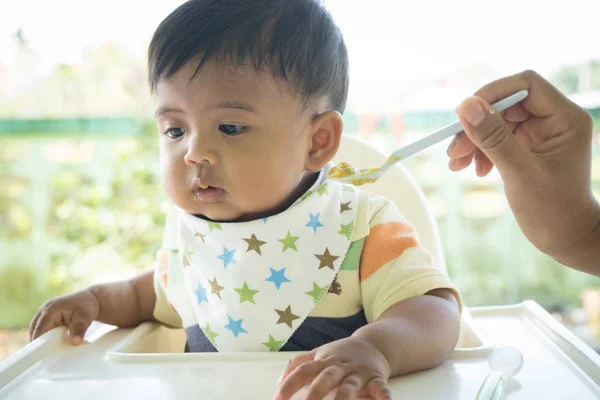 Cute asian baby bored with food — Stock Photo, Image