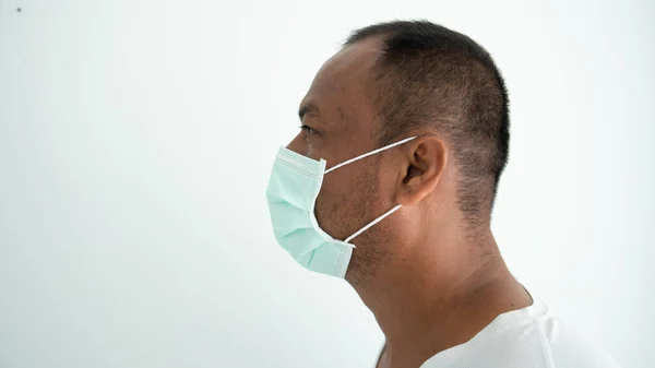 Young man sick and wearing mask on face