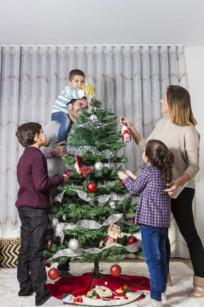 Family decorating Christmas tree — Stock Photo, Image