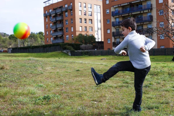 Boy kicking a ball — Stock Photo, Image