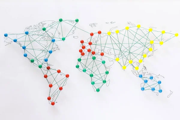 Map of the world connected by pushpins.