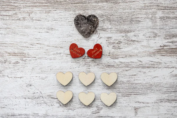 Hearts celebrating a wedding on a wooden background — Stock Photo, Image
