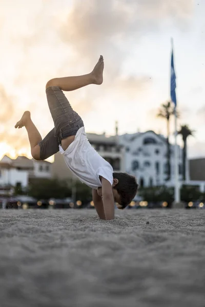 Little child making a somersault on the beach — Stock Photo, Image