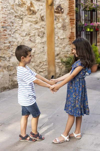 Twee kinderen die elkaars hand vasthouden op een lentedag — Stockfoto