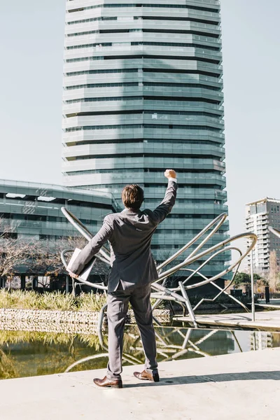 Euphoric businessman with a financial building background