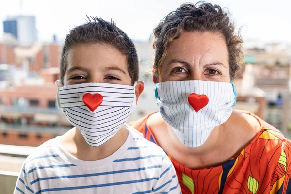 Mother and son with hearts in their face masks
