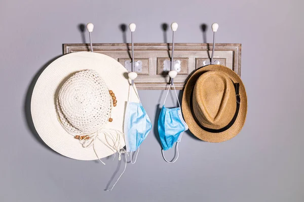 Coat rack with a hats and a pair of safety masks